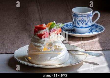Tasty Pavlova Dessert with strawberry. Summer aesthetics vibes background. Meringue-based dessert. Mini Pavlova with strawberry. Stock Photo
