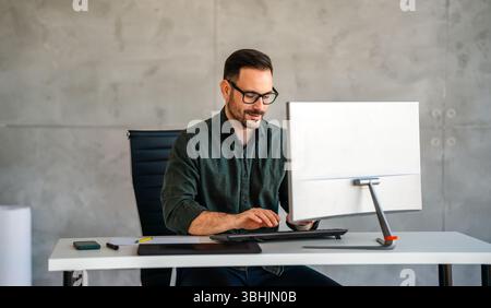 Happy professional business man company employee, young entrepreneur, smiling businessman working Stock Photo