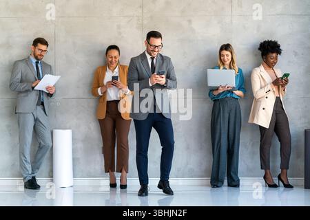 Happy businesspeople laughing while collaborating on a new project in an office. Stock Photo