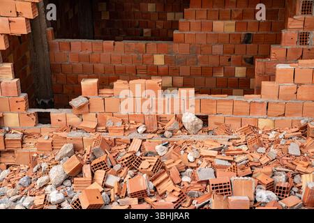 Collapsed wall and shattered bricks at construction site. High quality photo Stock Photo