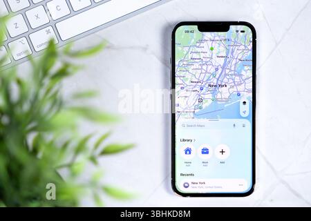 Poznan, Poland - June 10, 2025: Apple Maps application on a New iOS 26 iPhone, featuring New Liquid Glass in design, depicting New York Stock Photo
