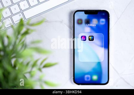 Poznan, Poland - June 10, 2025: Innovative mobile device featuring new iOS 26 and Liquid Glass design, showcasing Utilities, Shortcuts, Passwords for Stock Photo