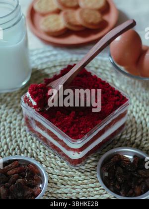 wooden spoon and delicious square red velvet cake in a box. concept photo for food promotion Stock Photo