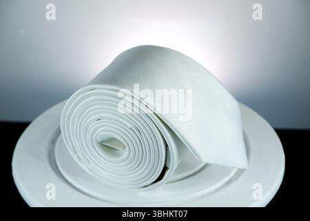 Rolled tie closeup shot against white background Stock Photo