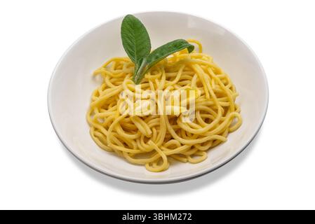 Egg noodles topped with butter and sage in white dish with butter slices and sage leaves, tagliolini in white dish isolated on white with clipping pat Stock Photo