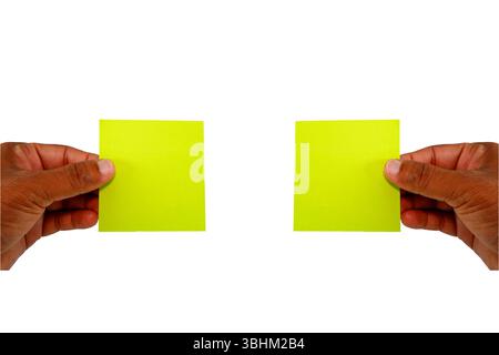 yellow card showing by two hands, sticky notes holding by hands with white background Stock Photo