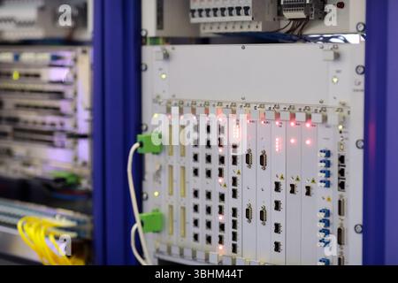 Rack mounted telecommunication equipment close up. Optical equipment for telephone networks and data transmission. Selective focus. Stock Photo