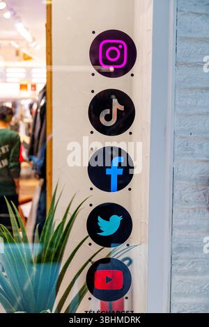 Casablanca, Casablanca-Settat - Morocco - 07-27-2024: Social media icons for Instagram, TikTok, Facebook, Twitter, and YouTube displayed on a store wi Stock Photo