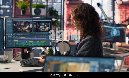 Young woman video editor working with dual monitors in creative agency, editing video footage and does color grading for the creative process. Post production to create content. Camera B. Stock Photo