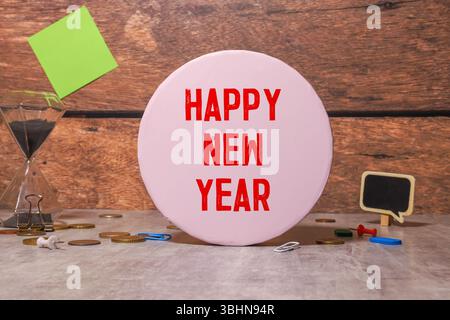 Happy new year 2025.Top view of lightbox with the word Happy new year 2025,crystal glasses and golden christmas balls on a gold glitter tablecloth. Ne Stock Photo