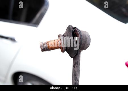 Stabilizer bar link worn out or stabilizer ball joint degraded, A close-up of a rusty, worn anti-roll bar link Stock Photo