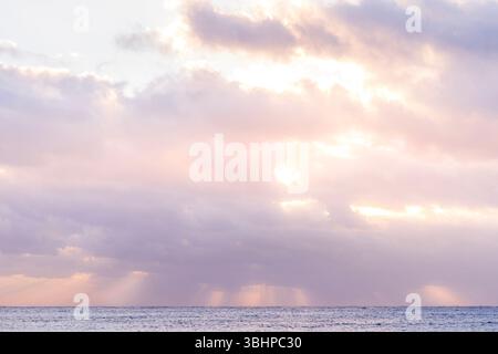 Serene Ocean Horizon At Sunset With Soft Pastel Colored Clouds. Tranquil Seascape, Pink Sky, Blue Water, Peaceful Nature Scene, Beautiful Calm Stock Photo