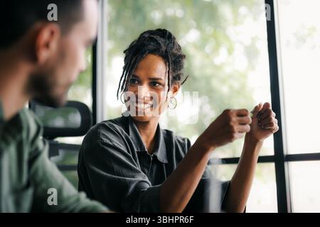 Cheerful diverse coworkers having fun during work break using technology enjoying working together Stock Photo
