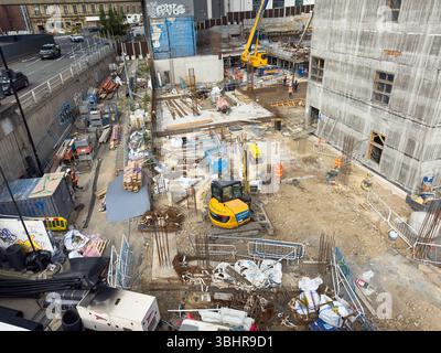 A busy construction site with machinery, materials, and workers, surrounded by urban infrastructure and buildings newcastle upon tyne uk Stock Photo