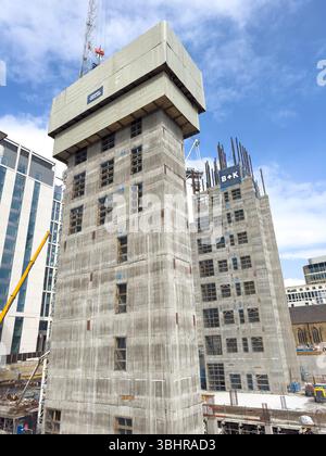 Construction site with two high-rise buildings under development surrounded by cranes and newcastle  skyline with concrete lift cores Stock Photo