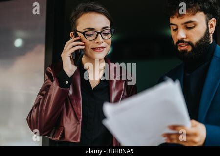 Professional Collaboration Between Two Colleagues Communicating and Reviewing Documents Stock Photo