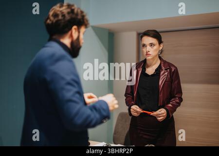 Two Professionals Engaged in a Serious Office Discussion Stock Photo