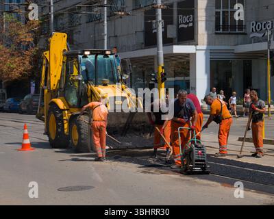 Road Maintenance Crew Working with Heavy Machinery and Tools on Asphalt Repairs in Sofia, Bulgaria Stock Photo