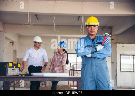 Construction engineer teamwork Safety Suit Trust Team Holding White Yellow Safety hard hat Security Equipment on Construction Site. Hardhat Protect He Stock Photo