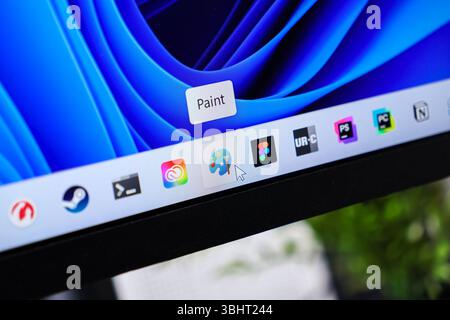 Poznan, Poland - June 6, 2025: Detailed view of a computer screen displaying a mouse cursor hovering over the Paint icon, showcasing creative software Stock Photo