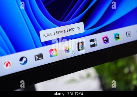 Poznan, Poland - June 6, 2025: iCloud Shared Albums app on a Windows 11 monitor, with a cursor highlighting cloud photo sharing features Stock Photo