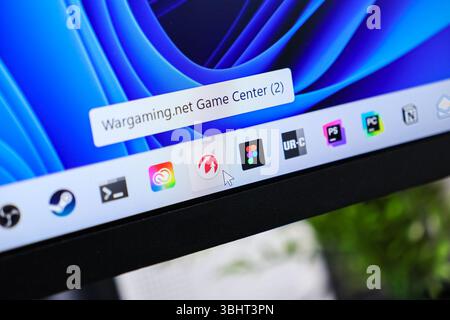 Poznan, Poland - June 6, 2025: Wargaming.net Game Center application icon highlighted by a mouse cursor on screen with various other software shortcut Stock Photo