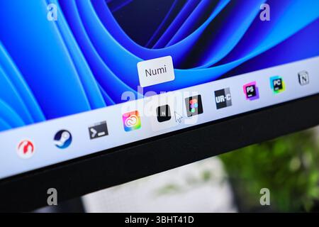 Poznan, Poland - June 6, 2025: Close-up of a computer screen with the Numi app icon highlighted on a modern desktop taskbar, illustrating digital tech Stock Photo