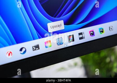 Poznan, Poland - June 6, 2025: Detailed view of a computer monitor's taskbar featuring the Upscayl application tooltip, representing a modern software Stock Photo