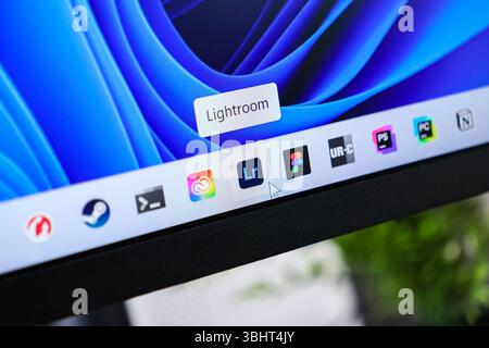 Poznan, Poland - June 6, 2025: Windows 11 desktop taskbar showcasing diverse application icons, highlighting Lightroom software with a cursor for crea Stock Photo