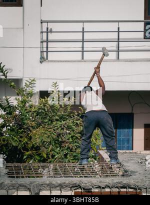 Feb'15th2025 Dehradun Uttarakhand India. Construction workers using jackhammer and hand hammers to dismantle a house for new construction. Manual labo Stock Photo