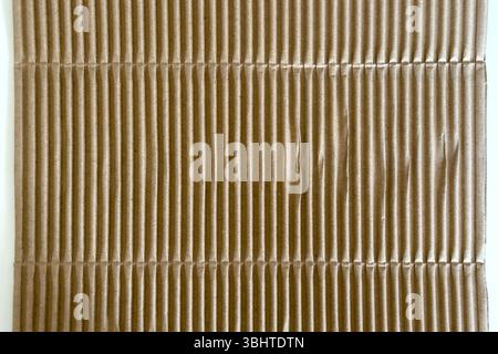 Corrugated brown packaging cardboard paper on white table. Abstract background Stock Photo