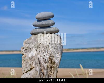 Photo by Guy Harrop. Pic of pebbles balanced on a post along the south west coast path, North Devon, UK Stock Photo