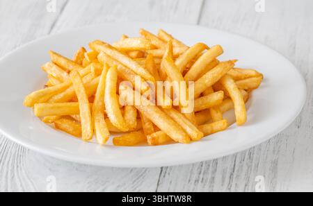 Crisp edges and golden glow highlight the irresistible simplicity of classic fries Stock Photo