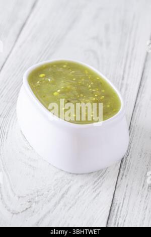 Bright green salsa verde swirled into bowl, tangy flavor with smooth texture Stock Photo