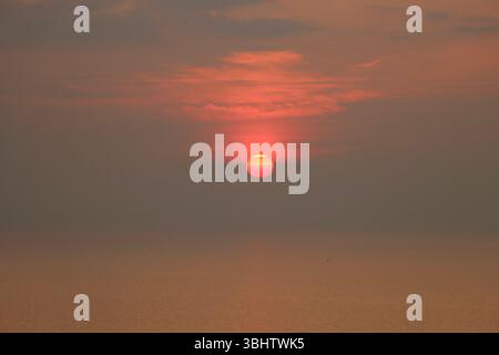 Smoke from Canadian prairie fires over Lake Erie at sunset on June 7th 2025 Stock Photo