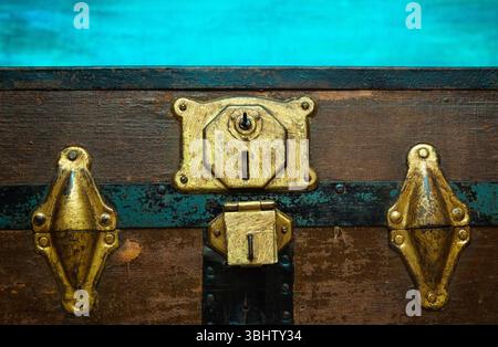 Antique shabby chest closed with an internal lock. Pirate chest. Stock Photo