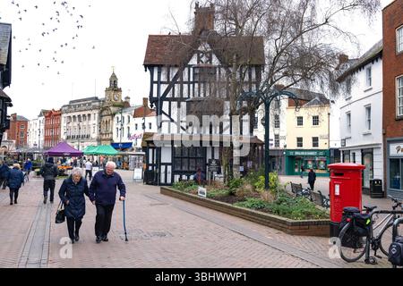 People in Hereford city centre, Hereford UK; street scene and  the 17th century Black and White House Museum,Herefordshire UK Stock Photo