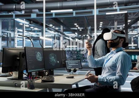 Data center engineer monitoring AI systems performance using VR headset, identifying bottlenecks. Artificial intelligence server farm worker troubleshooting glitches using virtual reality Stock Photo
