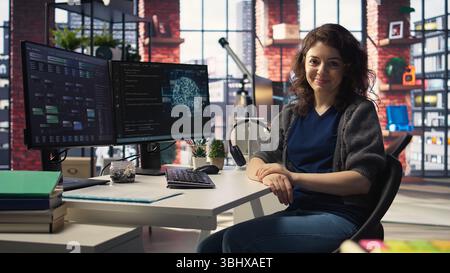 Admin writing code and doing maintenance on artificial intelligence neural networks computerized model. Woman tech support expert doing checkup on AI systems, data science. Camera A. Stock Photo