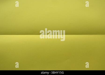 Folded yellow color paper for background. Stock Photo