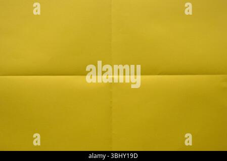 Folded yellow color paper for background. Stock Photo