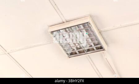 Ceiling-Mounted Reflective Fluorescent Light Fixture in Office Setting Stock Photo