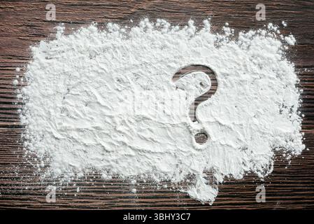 Question mark symbol written on a flour powder. Stock Photo