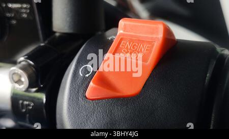 Red Engine Stop Switch on Black Surface with Rotational Arrow Symbol. Stock Photo