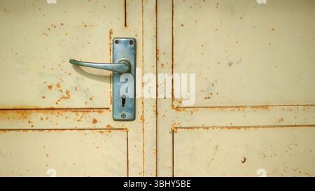 Vintage Door Handle on Rusty Metal Panel Stock Photo