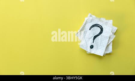 Question Mark on Paper Sheets with yellow Background Stock Photo