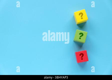 Colorful Wooden Blocks with Question Marks on Blue Background Stock Photo