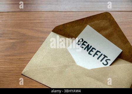 Envelope with Benefits Card Inside on Wooden Surface Stock Photo