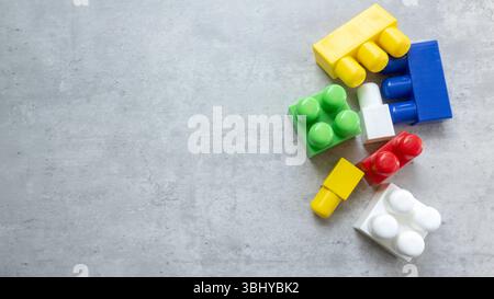 Colorful Plastic Building Blocks on Gray Surface Stock Photo