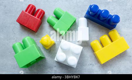 Colorful Plastic Building Blocks on Gray Surface Stock Photo